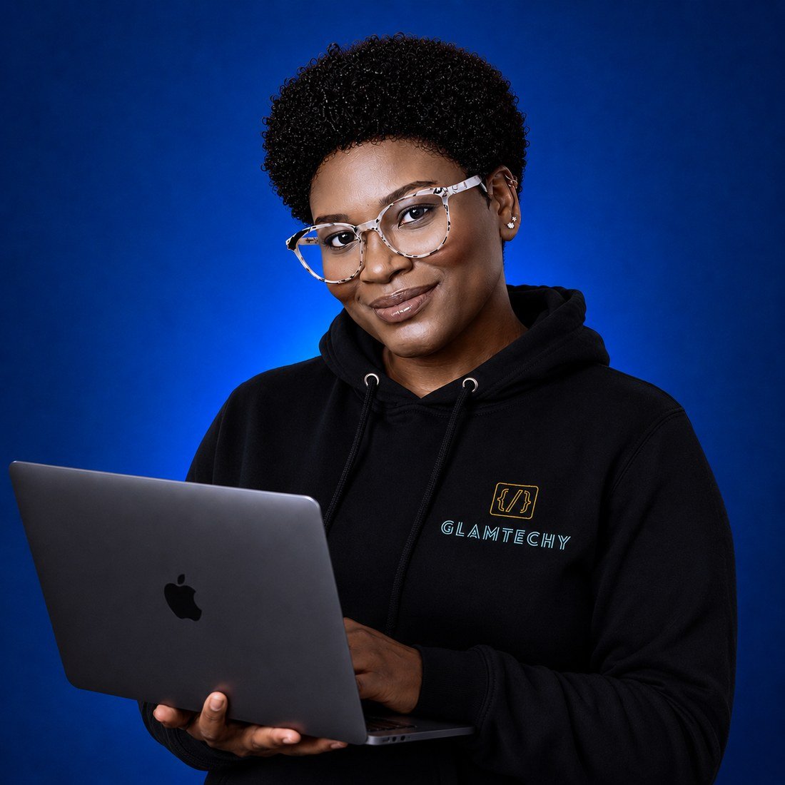 Khelseia Dunn, founder of Glamtechy, holding a laptop and wearing a black Glamtechy hoodie